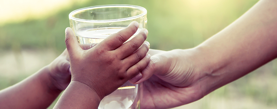 hands holding water glass
