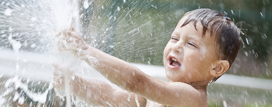 child with sprinkler